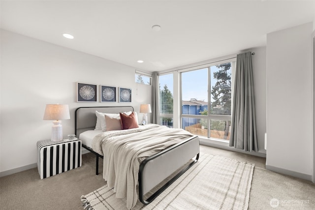 bedroom with recessed lighting, light colored carpet, and baseboards