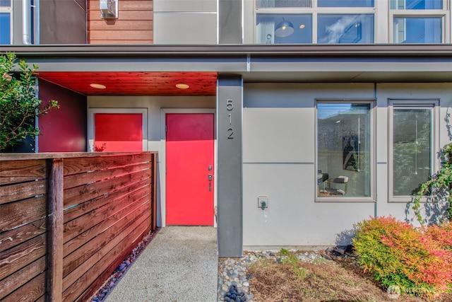 entrance to property featuring stucco siding