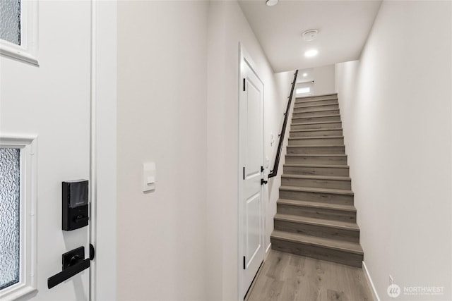 stairs featuring baseboards and wood finished floors