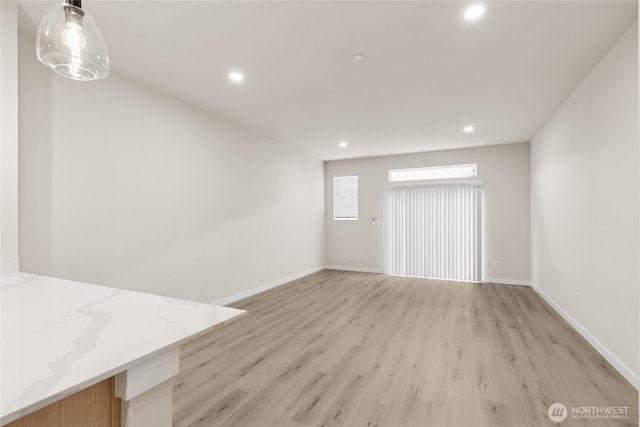 interior space featuring recessed lighting, light wood-type flooring, and baseboards