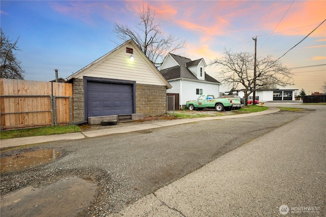 view of front facade with an outbuilding and fence