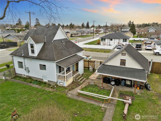 aerial view at dusk featuring a residential view