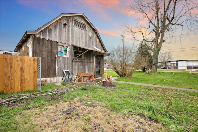 exterior space with a barn, a yard, and an outbuilding