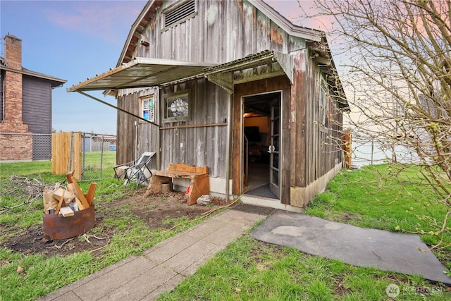 view of outbuilding featuring an outbuilding and fence