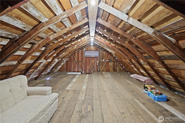 unfinished attic featuring an upstairs landing