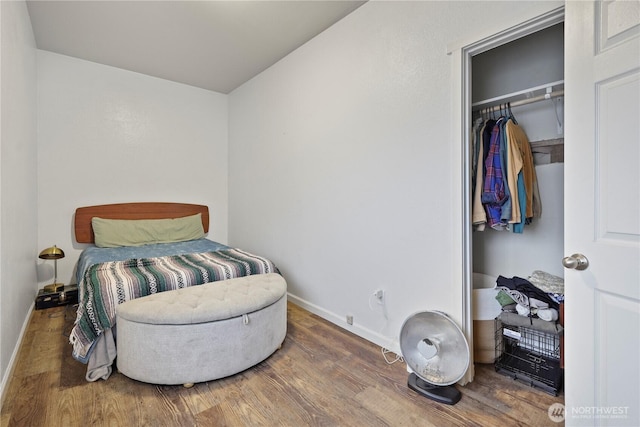 bedroom featuring baseboards and wood finished floors