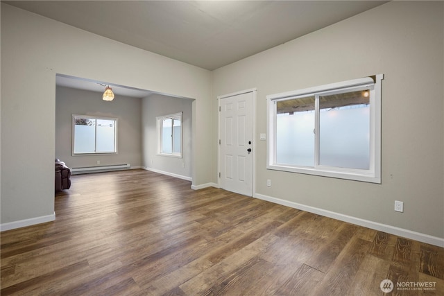 entryway with wood finished floors, baseboards, and baseboard heating