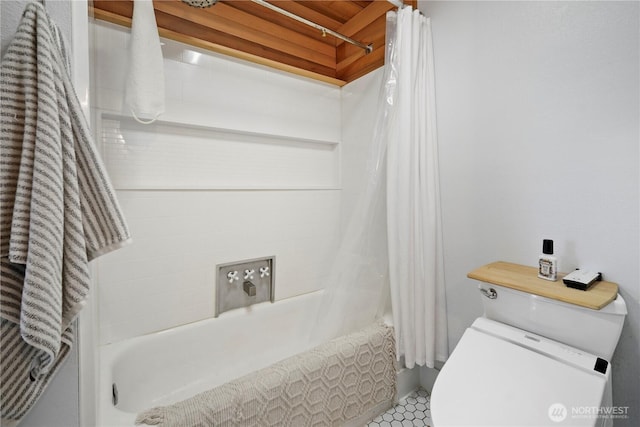 bathroom featuring shower / bath combination with curtain and toilet