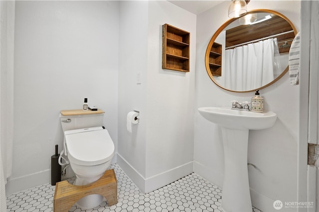 full bathroom with tile patterned flooring, toilet, and baseboards