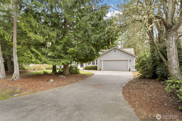 view of front of property with driveway and a garage