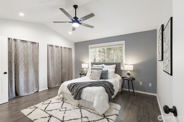 bedroom featuring a ceiling fan, lofted ceiling, wood finished floors, and baseboards