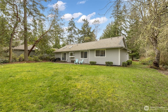 back of property featuring a patio area and a yard