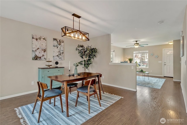 dining area with baseboards, dark wood-style floors, and a ceiling fan