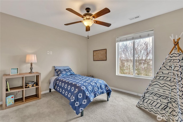 carpeted bedroom with a ceiling fan, baseboards, and visible vents