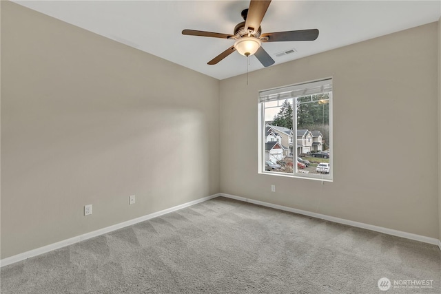 unfurnished room with visible vents, baseboards, carpet, and a ceiling fan