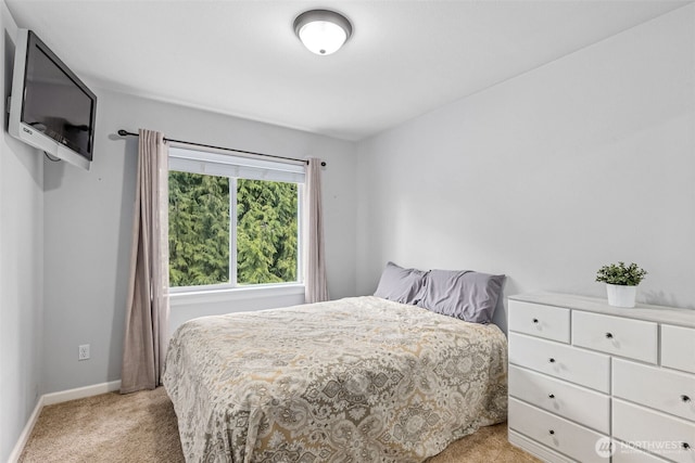 carpeted bedroom featuring baseboards