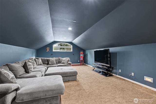 cinema room featuring lofted ceiling, baseboards, carpet floors, and a textured ceiling