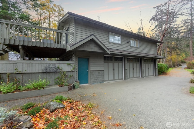 view of front of home with a garage and aphalt driveway