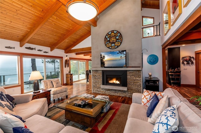 living room with a stone fireplace, beam ceiling, wood finished floors, and high vaulted ceiling