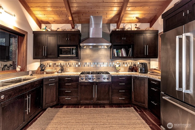 kitchen with wall chimney range hood, appliances with stainless steel finishes, dark wood finished floors, wooden ceiling, and vaulted ceiling with beams