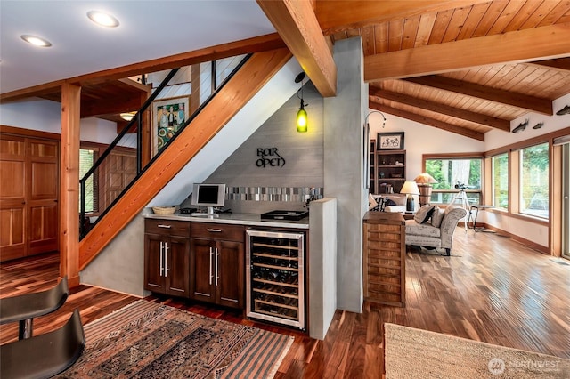 bar featuring dark wood-style flooring, lofted ceiling with beams, beverage cooler, stairs, and recessed lighting