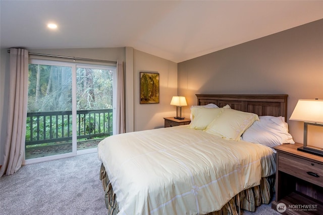 carpeted bedroom with vaulted ceiling and access to exterior