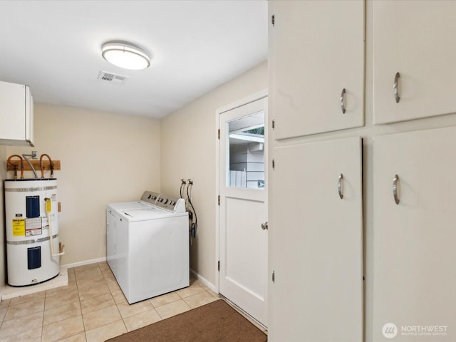 laundry room with visible vents, washer and dryer, strapped water heater, cabinet space, and light tile patterned flooring