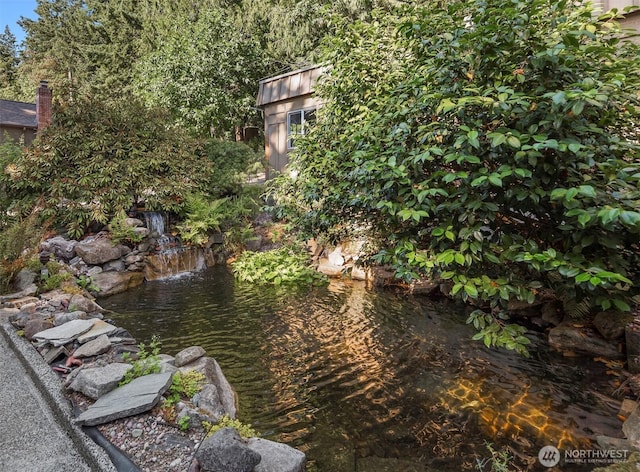 exterior space with a garden pond