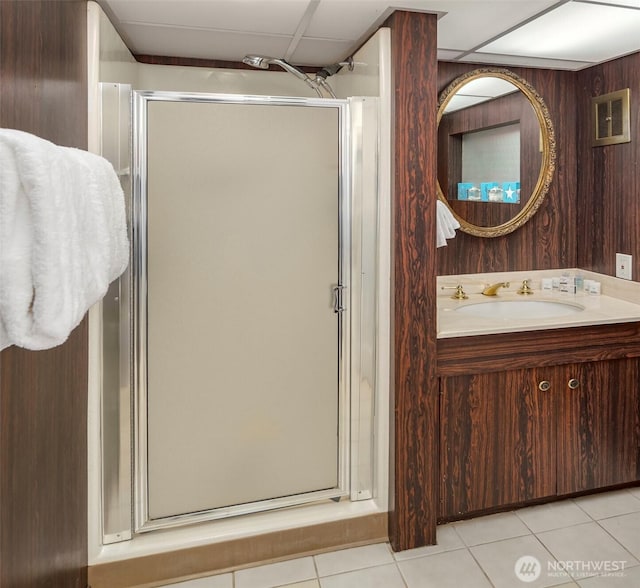 full bathroom featuring tile patterned flooring, a stall shower, and vanity