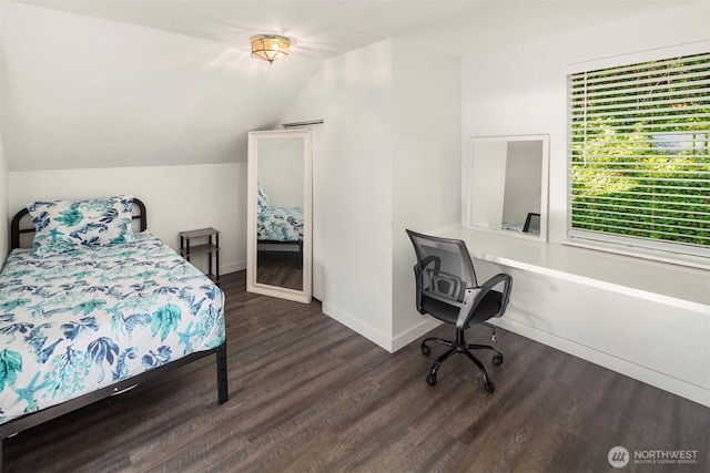 bedroom with vaulted ceiling, baseboards, and wood finished floors