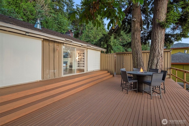 wooden terrace featuring an outdoor fire pit and outdoor dining area