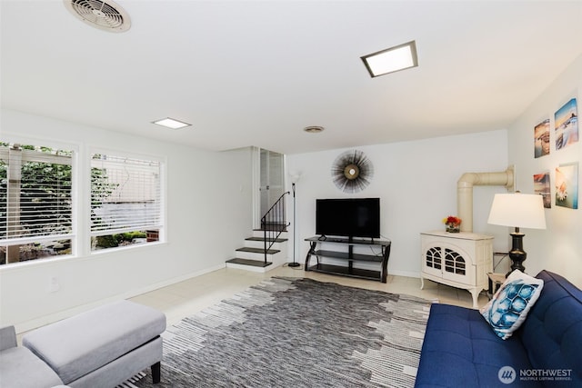 tiled living room with stairs, baseboards, and visible vents