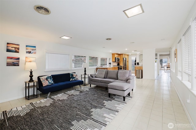 living area featuring light tile patterned floors, visible vents, recessed lighting, and baseboards