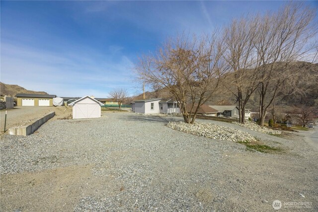 view of front of home with a storage shed and an outdoor structure