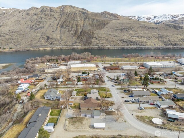 drone / aerial view with a water and mountain view