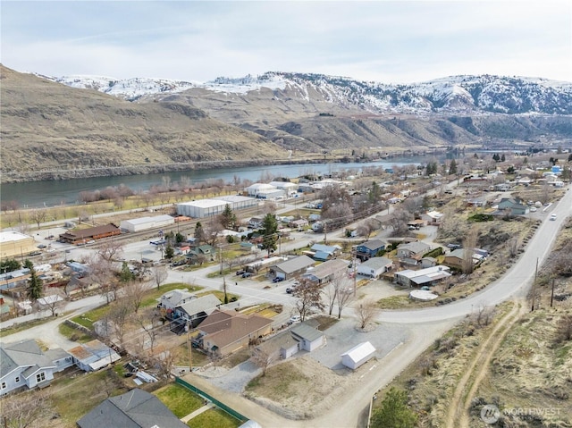 drone / aerial view with a residential view and a water and mountain view