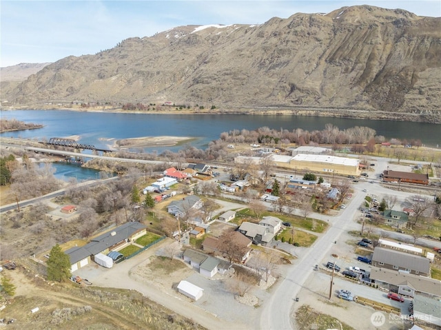 birds eye view of property with a water and mountain view