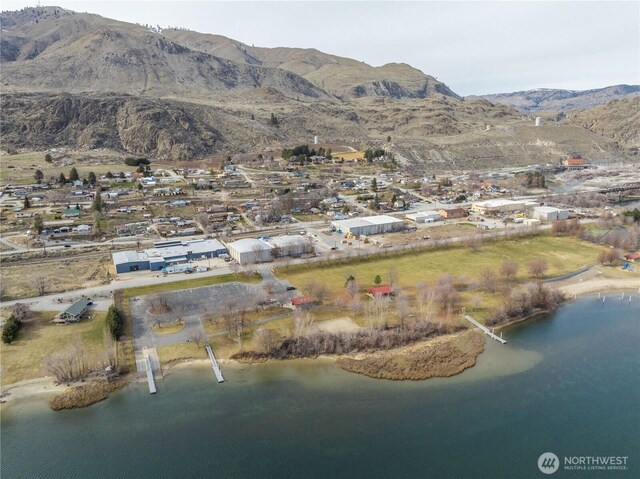 drone / aerial view with a water and mountain view