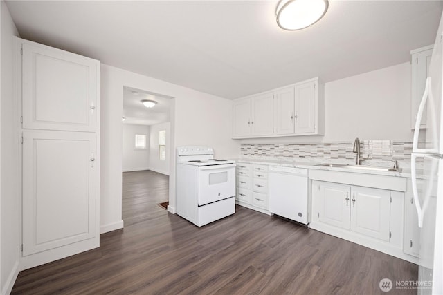 kitchen with a sink, white appliances, white cabinets, light countertops, and decorative backsplash