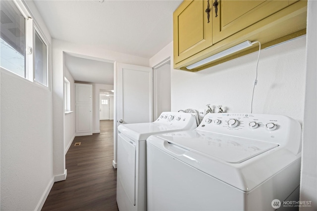 laundry room featuring dark wood finished floors, cabinet space, baseboards, and washer and clothes dryer