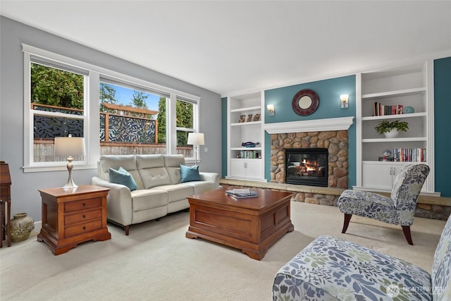 living room featuring built in shelves, carpet, and a fireplace