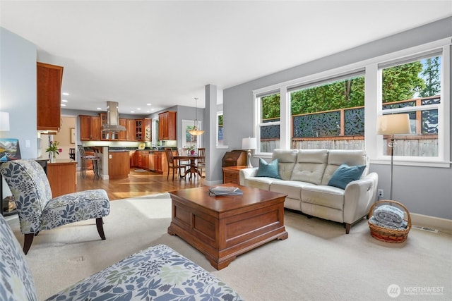 living room featuring recessed lighting, visible vents, and baseboards