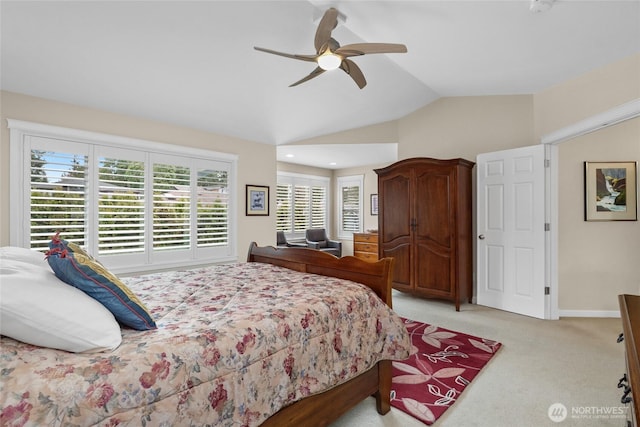 bedroom featuring light carpet, baseboards, ceiling fan, and vaulted ceiling