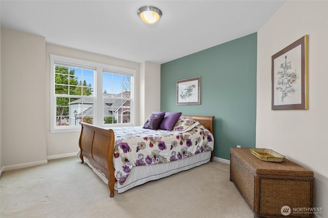 bedroom featuring baseboards and carpet