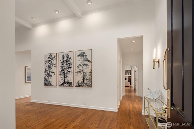 corridor featuring recessed lighting, beamed ceiling, baseboards, and wood finished floors