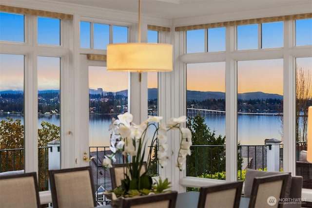 sunroom / solarium featuring a water view