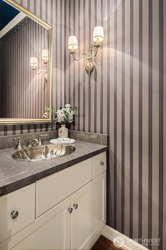 bathroom featuring wallpapered walls and vanity