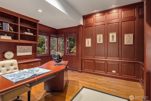 office area featuring visible vents, recessed lighting, wood walls, and light wood-style floors