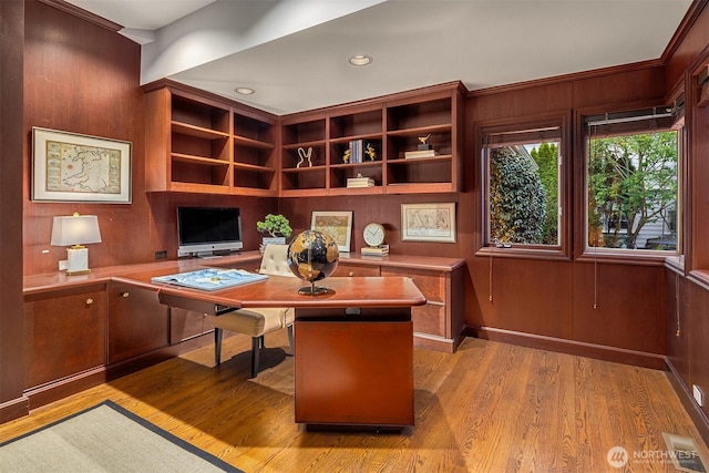 office area with recessed lighting, visible vents, light wood finished floors, and wood walls