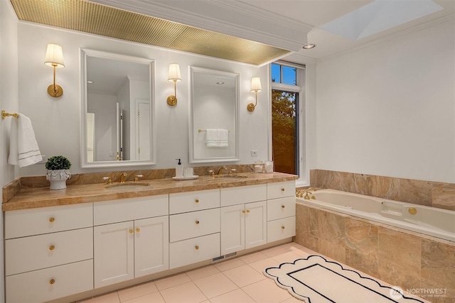 bathroom featuring tile patterned floors, double vanity, a bath, and a sink